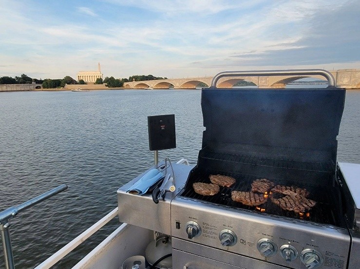Private boat charter deck featuring an outdoor grill with views of Arlington Memorial Bridge